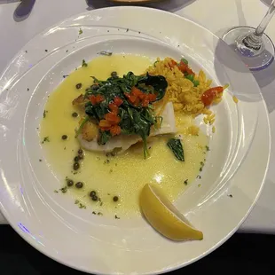 Chilean Sea Bass with lemon and capers topped with greens