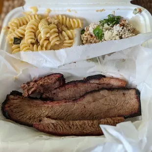 a tray of meat and macaroni and cheese