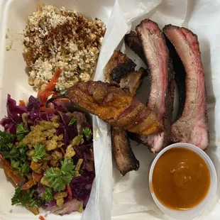 Rib plate with smoky esquites, delta slaw, jalapeño popper and smoked pear bourbon habanero sauce.