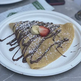 a crepe with chocolate and strawberries