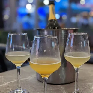 three glasses of champagne on a table