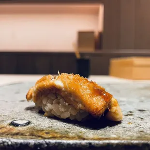a piece of sushi on a plate