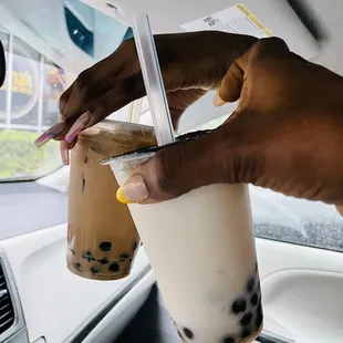 a hand holding a cup of bubble tea