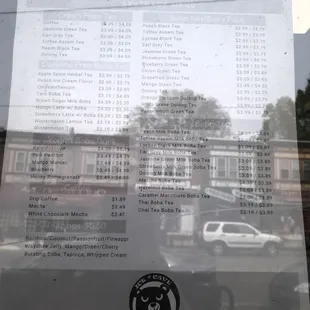 Window menu of drinks, reflection from across the street