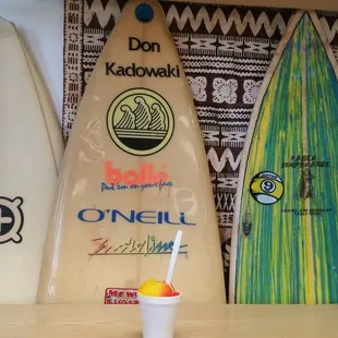 three surfboards and a drink