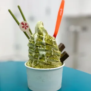 a bowl of ice cream with chopsticks