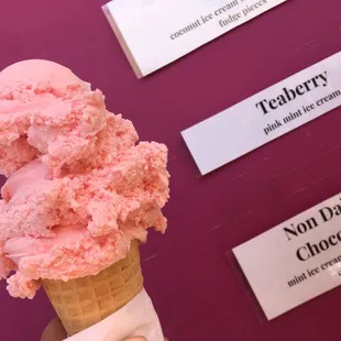 a hand holding a cone of ice cream