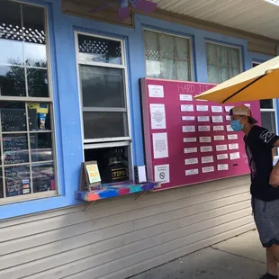 a man standing under an umbrella