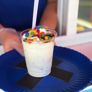 a cup of milkshake with candy