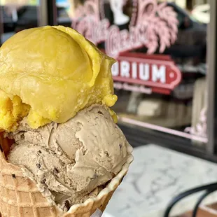 Tangerine sorbet and Expresso chip ice cream on a waffle cone.