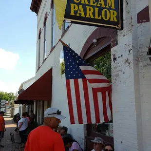 people sitting at tables outside