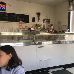 a young girl sitting in front of the counter