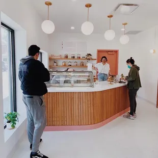 two people standing in front of a counter
