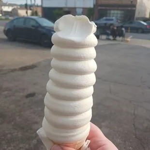 a hand holding an ice cream cone