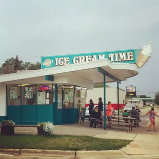 people sitting at picnic tables