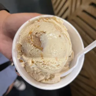 a person holding a cup of ice cream