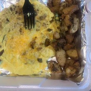 Full omelet with some bacon and potatoes