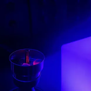 a lit candle in a glass