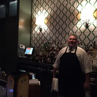 a man standing in front of the bar