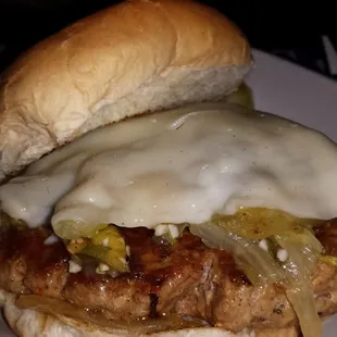 Sausage &amp; greens sandwich.  Hot Italian sausage patty, Italian fried greens, provolone cheese.