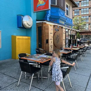 a little girl walking down the sidewalk