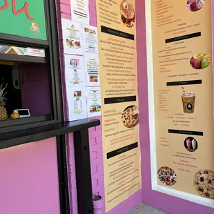 a menu on a pink wall