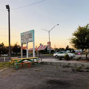 They have some picnic tables to hangout and eat your snow cone. August 2021.