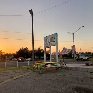 They have some picnic tables to hangout and eat your snow cone. August 2021.