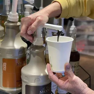 a woman's hand holding a cup