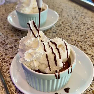 two cups of ice cream with chocolate drizzle