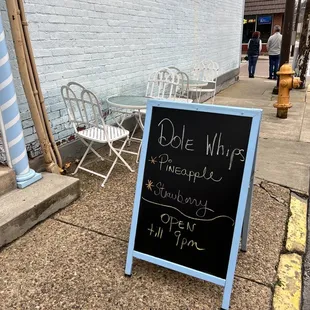a sign on the sidewalk