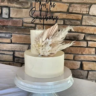 a white cake with feathers on top