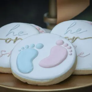 three cookies decorated with baby feet