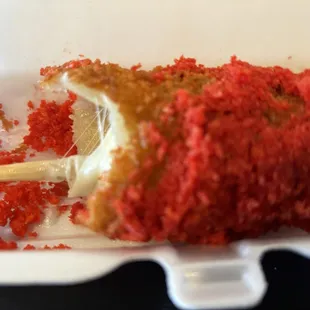 Hot Cheetos corn dog with half cheese and half hot dog