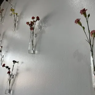 vases of flowers on a wall