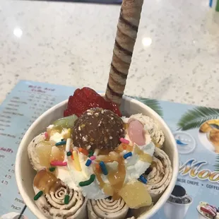 a cup of ice cream with toppings