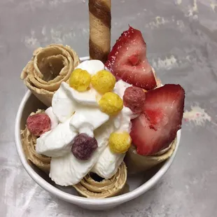 a bowl of ice cream and strawberries