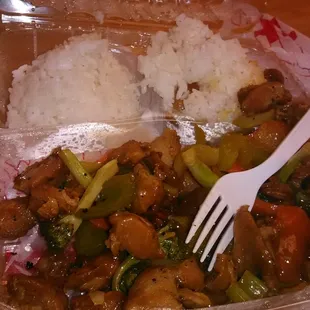 a plastic container with rice and vegetables