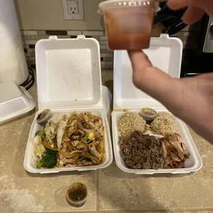 two takeout containers of food