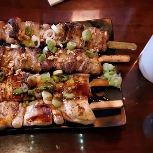 skewered skewers on a black plate