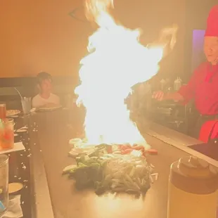 a woman in a red hat cooking food