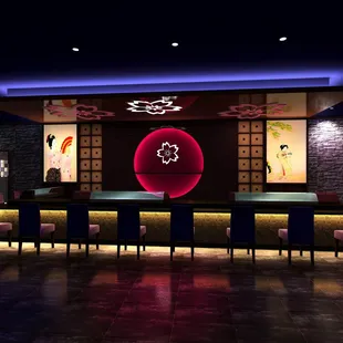 a restaurant with a long table and purple chairs