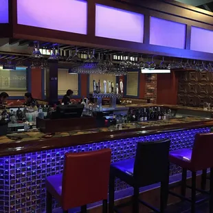 a bar with purple lighting