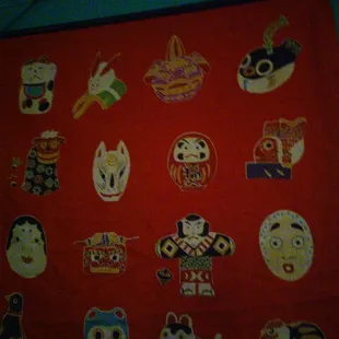 a red table cloth with a variety of japanese characters on it