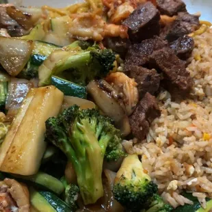 Filet mignon, shrimp, and chicken hibachi dinner with rice and noodles