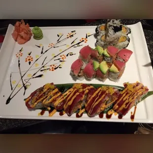 a plate of sushi and rolls