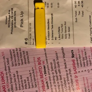 Menu we got with our order and our receipt - we got charged $5 more per person than we should have