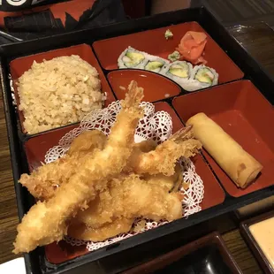 a tray of food with rice and vegetables