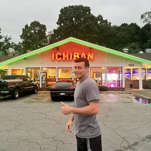a man standing in front of a restaurant