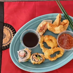 My takeout sampler plate: Gyoza, Crab Rangoon, Calamari, Las Vegas Roll, and Crunchy Roll with gyoza and Rangoon sauce.